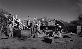 Movie still from “Lilies of the Field” (1963), directed by Ralph Nelson – A black and white photo of people working on a building; Wide shot, Low angle