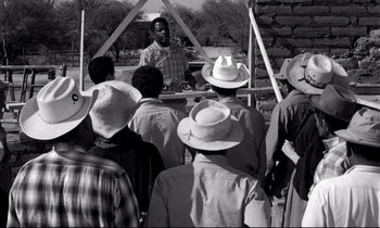 Movie still from “Lilies of the Field” (1963), directed by Ralph Nelson – A group of people standing in front of a crowd; Medium shot, Over the shoulder angle