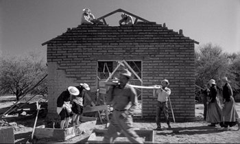 Movie still from “Lilies of the Field” (1963), directed by Ralph Nelson – A black and white photo of men working on a building; Extreme Wide shot, Low angle