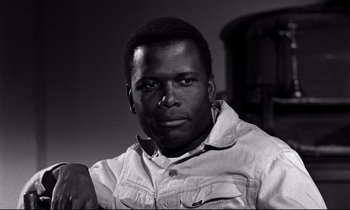 Movie still from “Lilies of the Field” (1963), directed by Ralph Nelson – A black and white photo of a man in a white shirt; Close Up shot, Low angle