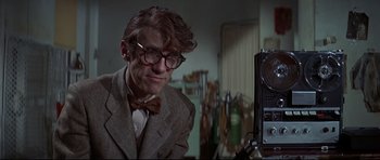 Movie still from “Little Big Man” (1970), directed by Arthur Penn – A man in a suit and bow tie looking at a camera; Close Up shot, Low angle