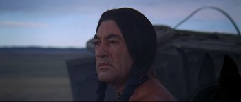 Movie still from “Little Big Man” (1970), directed by Arthur Penn – An older man with a long black hair and a beard; Close Up shot, Low angle