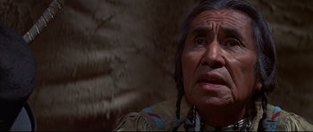 Movie still from “Little Big Man” (1970), directed by Arthur Penn – An older native american man in a native dress; Close Up shot, Over the shoulder angle