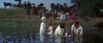 Movie still from “Little Big Man” (1970), directed by Arthur Penn – A group of people standing in the water; Wide shot, High angle
