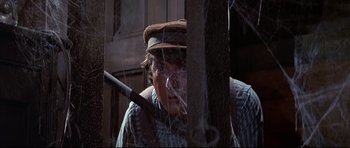 Movie still from “Little Big Man” (1970), directed by Arthur Penn – A young man in a hat and a shirt looking at the camera; Close Up shot, Low angle