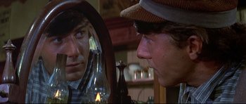 Movie still from “Little Big Man” (1970), directed by Arthur Penn – A man looking in the mirror while looking at another man; Close Up shot, Over the shoulder angle