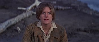Movie still from “Little Big Man” (1970), directed by Arthur Penn – A man with a brown jacket and blue eyes looking at the camera; Close Up shot, Low angle