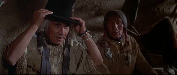 Movie still from “Little Big Man” (1970), directed by Arthur Penn – Two native american men in traditional clothing; Close Up shot, Low angle