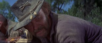Movie still from “Little Big Man” (1970), directed by Arthur Penn – An old man with a beard wearing a hat; Close Up shot, Low angle