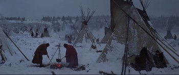 Movie still from “Little Big Man” (1970), directed by Arthur Penn – A person standing in the snow next to a teepee; Wide shot, High angle