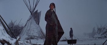Movie still from “Little Big Man” (1970), directed by Arthur Penn – A native american woman standing in front of a teepee; Wide shot, Low angle