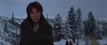 Movie still from “Little Big Man” (1970), directed by Arthur Penn – A man wrapped in a blanket standing in the snow; Medium shot, Low angle
