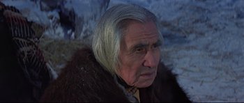 Movie still from “Little Big Man” (1970), directed by Arthur Penn – An older man with long white hair wearing a fur coat; Close Up shot, Over the shoulder angle