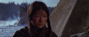 Movie still from “Little Big Man” (1970), directed by Arthur Penn – A young girl with braids and a green shirt; Close Up shot, Low angle