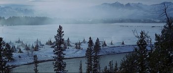 Movie still from “Little Big Man” (1970), directed by Arthur Penn – Many teepees in the snow by the water; Extreme Wide shot, High angle