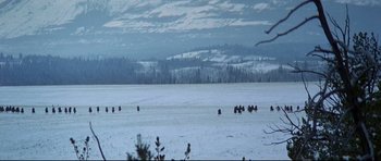 Movie still from “Little Big Man” (1970), directed by Arthur Penn – A group of people riding horses across a snow covered field; Extreme Wide shot, High angle