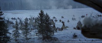 Movie still from “Little Big Man” (1970), directed by Arthur Penn – A group of people riding horses across a snow covered field; Extreme Wide shot, High angle