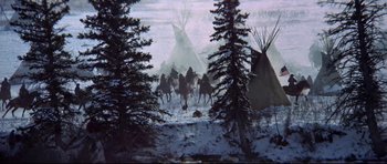 Movie still from “Little Big Man” (1970), directed by Arthur Penn – A group of people riding horses in the snow near tents; Wide shot, High angle