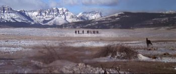 Movie still from “Little Big Man” (1970), directed by Arthur Penn – A group of people standing on top of a snow covered field; Extreme Wide shot, High angle