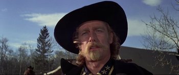 Movie still from “Little Big Man” (1970), directed by Arthur Penn – A person wearing a cowboy hat; Close Up shot, Low angle