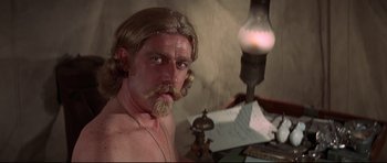 Movie still from “Little Big Man” (1970), directed by Arthur Penn – A man with long blond hair and a mustache; Close Up shot, High angle