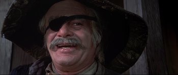 Movie still from “Little Big Man” (1970), directed by Arthur Penn – An older man with a mustache and a hat; Close Up shot, Low angle