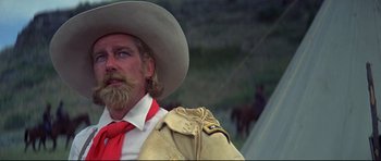 Movie still from “Little Big Man” (1970), directed by Arthur Penn – A man with a beard and a cowboy hat; Close Up shot, Low angle