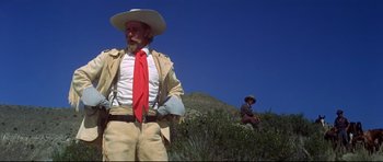 Movie still from “Little Big Man” (1970), directed by Arthur Penn – A man with a red tie standing next to another man in a hat; Medium shot, Low angle