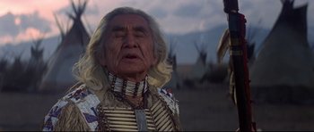 Movie still from “Little Big Man” (1970), directed by Arthur Penn – An older native american man in traditional clothing; Close Up shot, Low angle