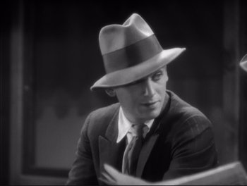 Movie still from “Little Caesar” (1931), directed by Mervyn LeRoy – A black and white photo of a man wearing a hat; Close Up shot, High angle