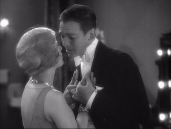 Movie still from “Little Caesar” (1931), directed by Mervyn LeRoy – A man and a woman are dancing together in formal wear; Close Up shot, High angle