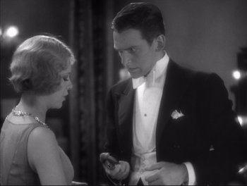 Movie still from “Little Caesar” (1931), directed by Mervyn LeRoy – A man and a woman in formal wear looking at each other; Medium shot, Low angle