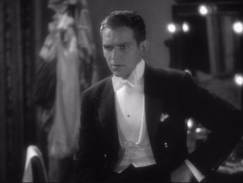 Movie still from “Little Caesar” (1931), directed by Mervyn LeRoy – A man in a tuxedo sitting in front of a mirror; Medium shot, Low angle