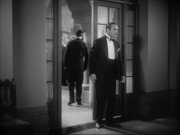 Movie still from “Little Caesar” (1931), directed by Mervyn LeRoy – A black and white photo of a man in a tuxedo; Medium shot, Low angle