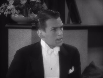 Movie still from “Little Caesar” (1931), directed by Mervyn LeRoy – A man in a tuxedo is sitting in front of a wall; Close Up shot, High angle