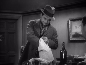 Movie still from “Little Caesar” (1931), directed by Mervyn LeRoy – A black and white photo of a man in a hat; Medium shot, Low angle