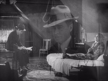 Movie still from “Little Caesar” (1931), directed by Mervyn LeRoy – A black and white photo of a man in a hat; Wide shot, High angle