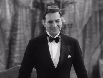 Movie still from “Little Caesar” (1931), directed by Mervyn LeRoy – A man wearing a tuxedo and a bow tie; Medium shot, Low angle