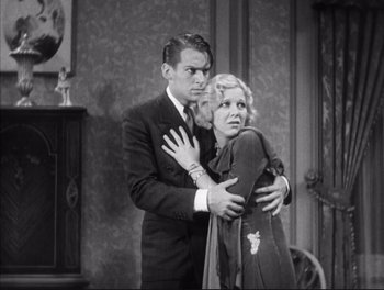 Movie still from “Little Caesar” (1931), directed by Mervyn LeRoy – A man and a woman hugging in a room; Medium shot, High angle