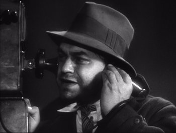 Movie still from “Little Caesar” (1931), directed by Mervyn LeRoy – A black and white photo of a man in a hat; Close Up shot, Low angle