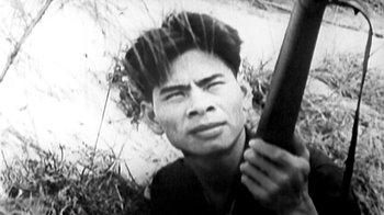 Movie still from “Little Dieter Needs to Fly” (1997), directed by Werner Herzog – An old photo of a man holding a rifle; Close Up shot, High angle