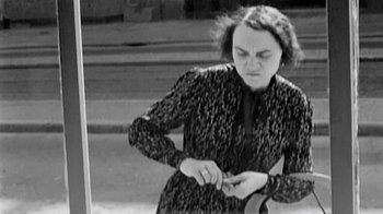 Movie still from “Little Dieter Needs to Fly” (1997), directed by Werner Herzog – An old photo of a woman tying a tie; Medium shot, Low angle