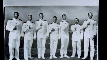 Movie still from “Little Dieter Needs to Fly” (1997), directed by Werner Herzog – A black and white photo of a group of men in uniform; Wide shot, High angle