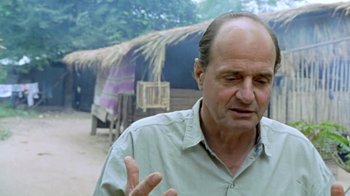Movie still from “Little Dieter Needs to Fly” (1997), directed by Werner Herzog – An older man in a green shirt talking to someone; Close Up shot, Over the shoulder angle
