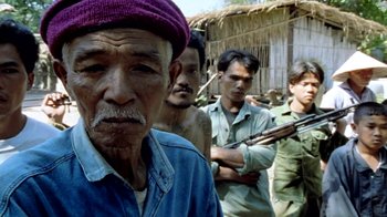Movie still from “Little Dieter Needs to Fly” (1997), directed by Werner Herzog – A group of men standing next to each other holding guns; Close Up shot, High angle