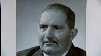 Movie still from “Little Dieter Needs to Fly” (1997), directed by Werner Herzog – An older man wearing a suit and tie; Close Up shot, Low angle