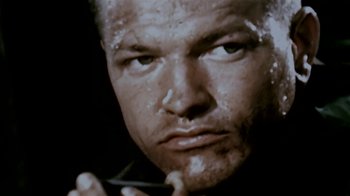 Movie still from “Little Dieter Needs to Fly” (1997), directed by Werner Herzog – A man's face in a black and white photo; Extreme Close Up shot, Low angle