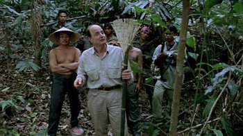 Movie still from “Little Dieter Needs to Fly” (1997), directed by Werner Herzog – A group of people standing in the woods; Medium shot, Over the shoulder angle