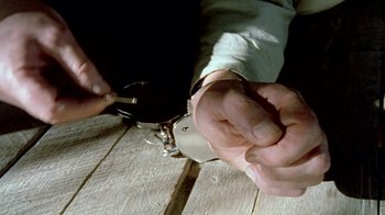 Movie still from “Little Dieter Needs to Fly” (1997), directed by Werner Herzog – A man with a pair of handcuffed hands; Extreme Close Up shot, Overhead angle