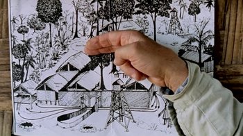 Movie still from “Little Dieter Needs to Fly” (1997), directed by Werner Herzog – A hand holding a piece of paper in front of a drawing; Extreme Close Up shot, Overhead angle